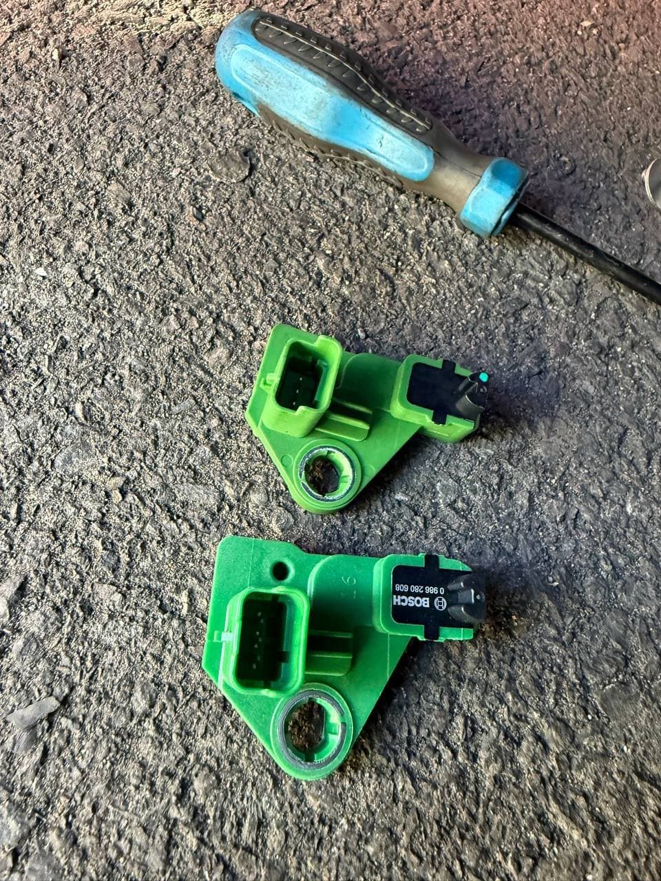 Two Bosch engine sensors side by side, the replacement and the one removed